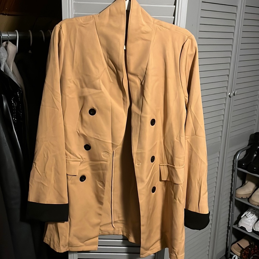 Beige blazer with black cuffs
